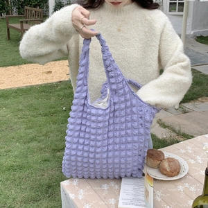 Close-up of purple bubble texture fabric tote bag featuring a stylish puffy quilted design