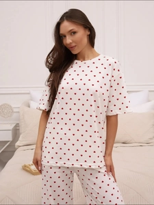 Detailed shot of soft white pajama set with red heart print and short sleeves