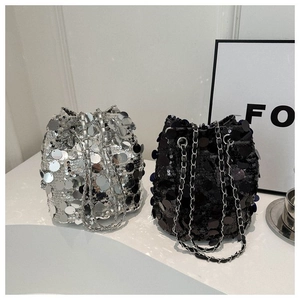 Sparkly sequin bucket bag with drawstring closure and metal chain strap in black and silver