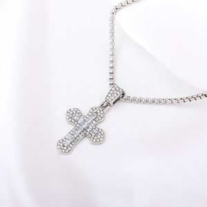 Elegant silver cross necklace featuring sparkling red and clear crystals on silk fabric