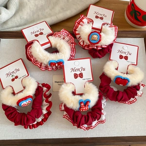 5-piece set of plush polka dot scrunchies in warm red and beige tones for women