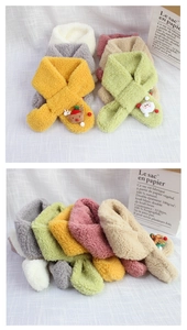 Detail of plush Christmas scarves with cute reindeer and Santa Claus decorations