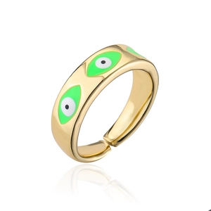 Detail of adjustable gold-plated ring with green evil eye enamel patterns and mirror reflection