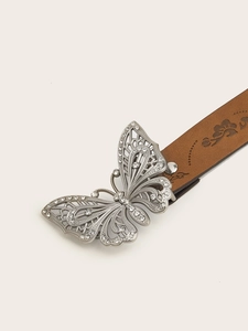 Detail of vintage Y2K brown leather belt with silver rhinestone butterfly buckle