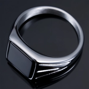 Vintage silver mens signet ring featuring a square black gemstone on reflective surface