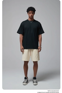 Detail of premium 190G black cotton oversized T-shirt paired with beige drawstring shorts