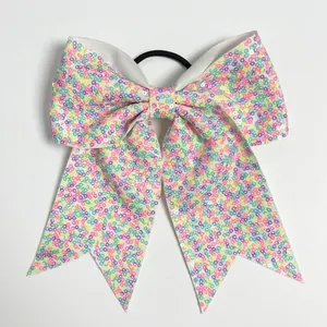 Macro detail of 8-inch sequin bow hair tie with vibrant multicolored glitter pattern