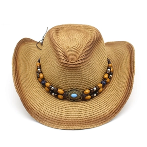 Brown woven western cowboy straw hat with bohemian turquoise bead band on white background