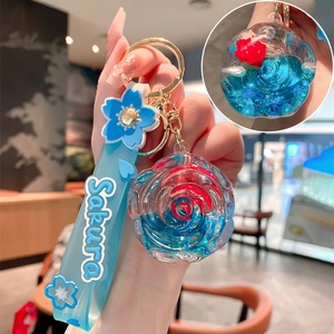 Blue resin rose liquid quicksand keychain with Sakura silicone wrist strap and gold clasp