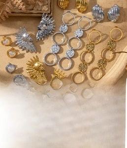 Detailed view of titanium steel heart and sun earrings with vacuum plating finish