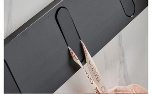Detail of matte black folding wall hook showing aluminum alloy texture and open-close structure