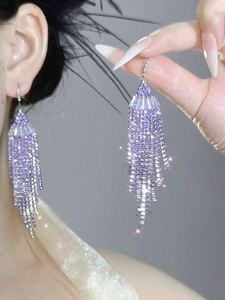 Macro detail of elegant purple rhinestone fringe tassel earrings with shimmering crystals