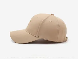 Detailed side view showing pineapple texture fabric and golden embroidery on khaki baseball cap