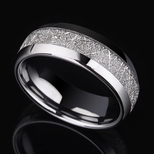 Macro view of polished stainless steel ring featuring grey meteorite texture inlay