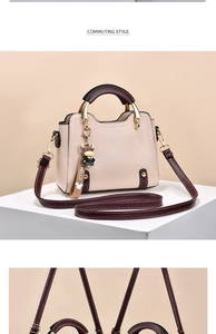 Close-up of beige and brown contrasting handbag with golden hardware and cute cow charm