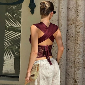 Detail of burgundy lace patchwork top showing cross-tie back design and floral texture