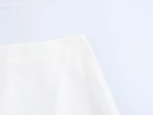 Close-up of elegant white floral skirt waistline with smooth chiffon fabric and neat stitching