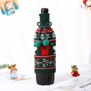 Festive Christmas knit wine bottle cover with snowflakes and pom pom drawstring