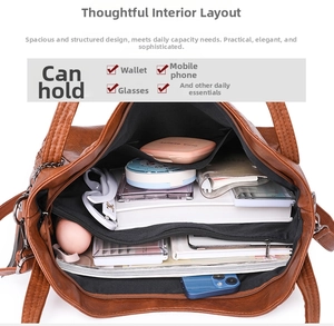 Top view of large brown leather tote interior showing spacious compartments and storage