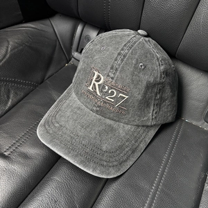 Close-up of R'27 embroidery and lettering on vintage washed grey cotton baseball cap