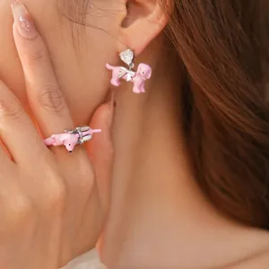 Pink enamel dachshund jewelry set featuring crystal bow earrings and a matching ring