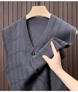 Detailed view of dark grey checkered knit vest cardigan with fabric texture and black buttons