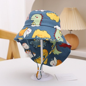 Detail of blue sun hat with dinosaur prints, featuring an adjustable windproof chin strap