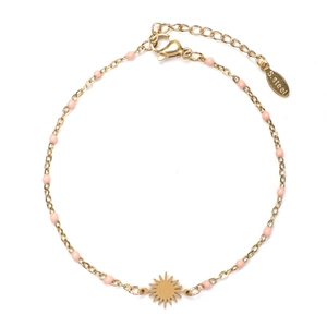 Macro detail of sun pendant with pink beads on golden stainless steel bracelet chain