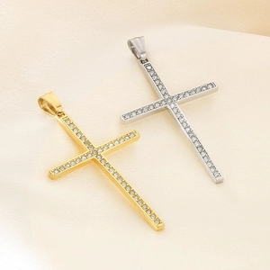 Detailed view of gold and silver hip hop cross pendants with sparkling rhinestones on silk