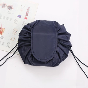 Detail of navy blue nylon drawstring makeup bag with quick closure and protective flap