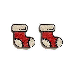 Close-up of red and white Christmas stocking wooden earrings with black stitching detail