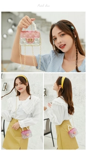 Macro detail of mini jelly bag with pink gradient lid, pearl handle and metal chain strap