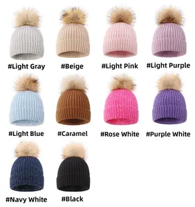 Close-up of fine ribbed knit baby beanies featuring faux fur pom-poms in ten colors