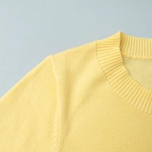 Detail of the round neckline and fine knit texture on a beige short-sleeved sweater