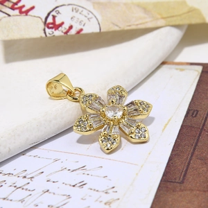 Minimalist gold floral pendant necklace with cubic zirconia on vintage stationery
