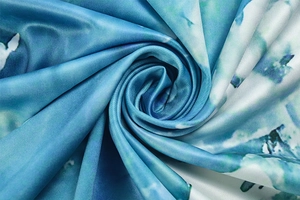 Macro shot of blue and white abstract print fabric showing silky texture and drape
