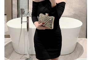 Detail of elegant evening clutch featuring colorful rhinestones and secure metal clasp closure