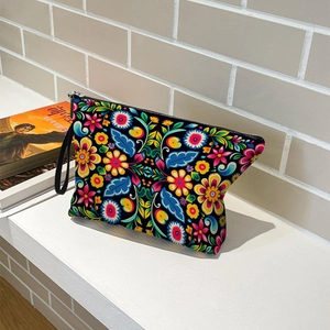 Floral print cosmetic bag with black wristlet and silver zipper for outdoor travel