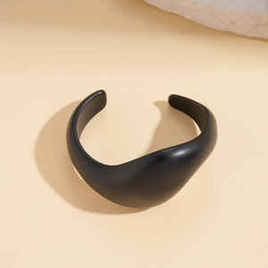 Sculptural black matte irregular cuff bracelet with asymmetric geometric flow design