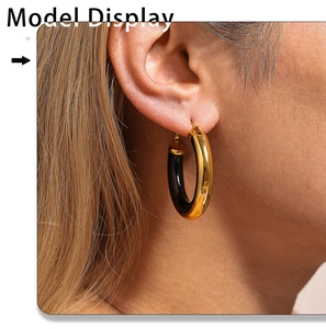 Close-up of elegant 18K gold plated hoop earring with black enamel on model ear