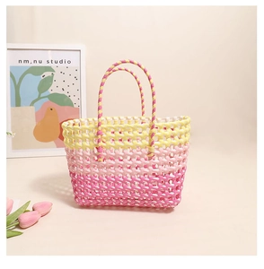 Detail of colorful hollow woven handbag with yellow to pink gradient and dual handles