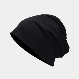 Detailed close-up showing the fine knitted texture and soft fabric of this black slouchy beanie
