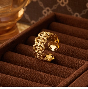 Detailed close-up of hollow flower vintage ring on a premium brown velvet display box