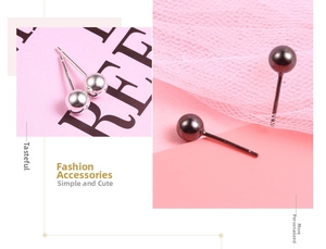 Detailed macro view of S925 sterling silver ball stud earrings in silver and black colors