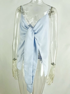 Detail of baby blue satin camisole top featuring a large elegant bow knot and thin straps