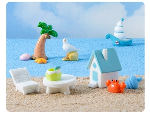 Miniature beach resort scene featuring a blue roof cabin, palm tree, and tiny deck chair