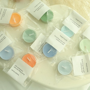 Colorful tealight candles in plastic shells with minimalist packaging for home decor