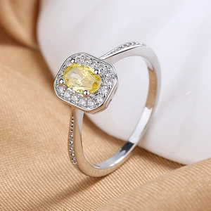 Elegant silver halo ring with oval yellow gemstone and sparkling side micro-pavé diamonds