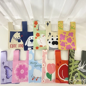 Collection of various knitted wrist bags with cute animal and floral patterns shown flatly