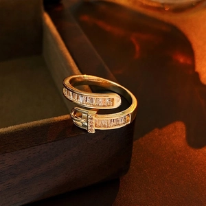 Gold-plated belt buckle ring with baguette-cut zircons and minimalist luxury design